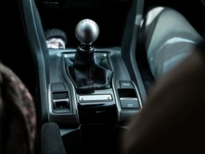 Closeup of a black modern manual car transmission gear shifter