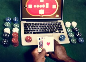 Hand holding card playing online gambling