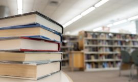 Stack of books on table at library